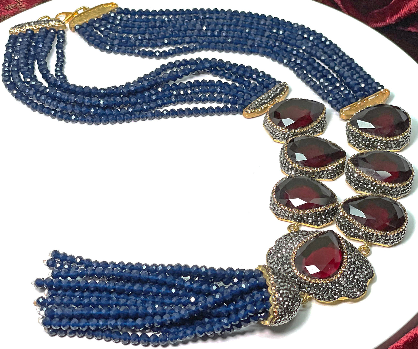 Artisan's necklace with ruby red color natural gemstone and blue crystals. Each natural gemstone is unique .